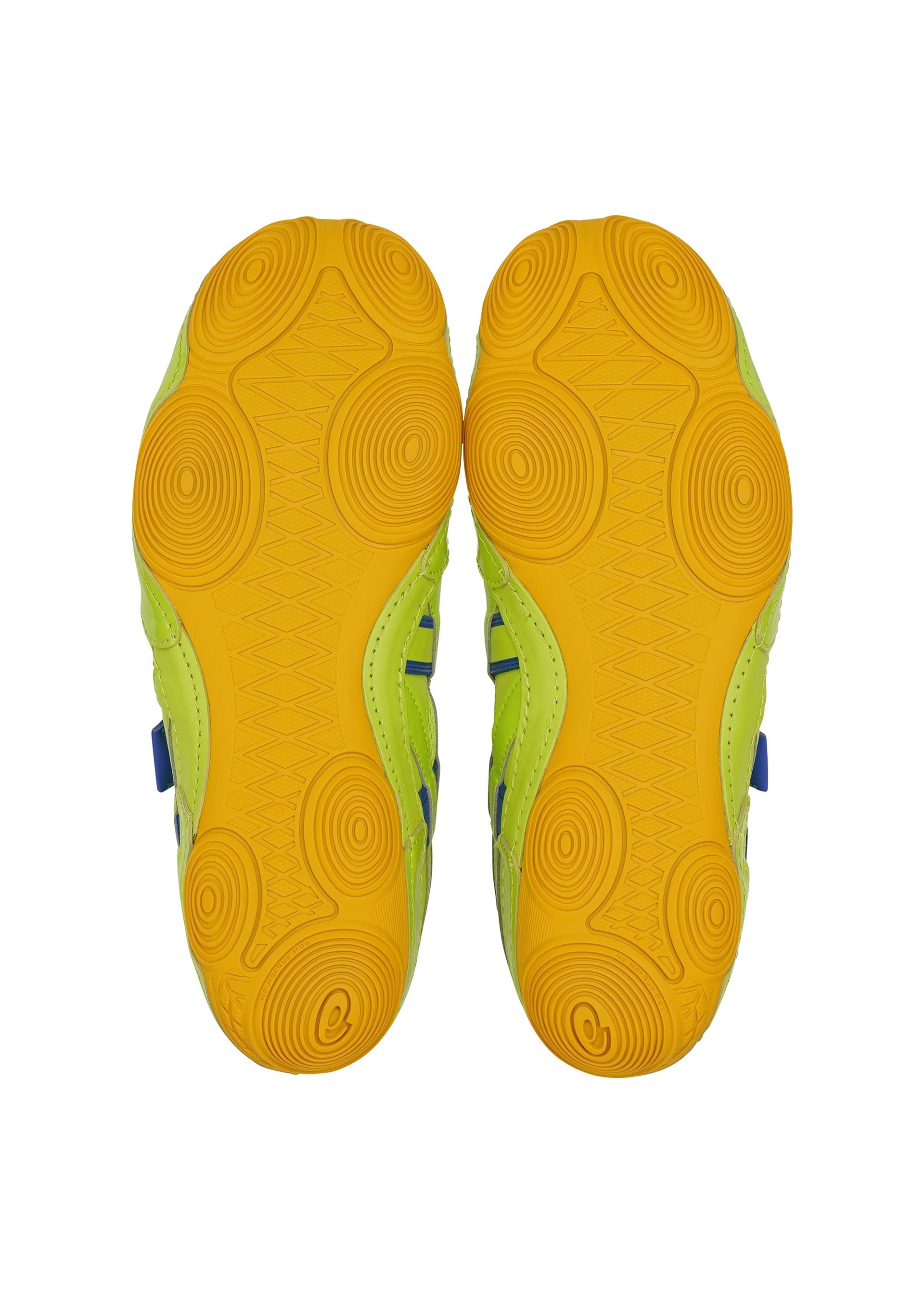 Zoomed view The HYPER TAPING sneakers by ISSEY MIYAKE FOOT are shown from below, displaying yellow rubber outsoles with circular and wavy patterns, plus green and blue accents on the sides—highlighting the brand’s bold design.