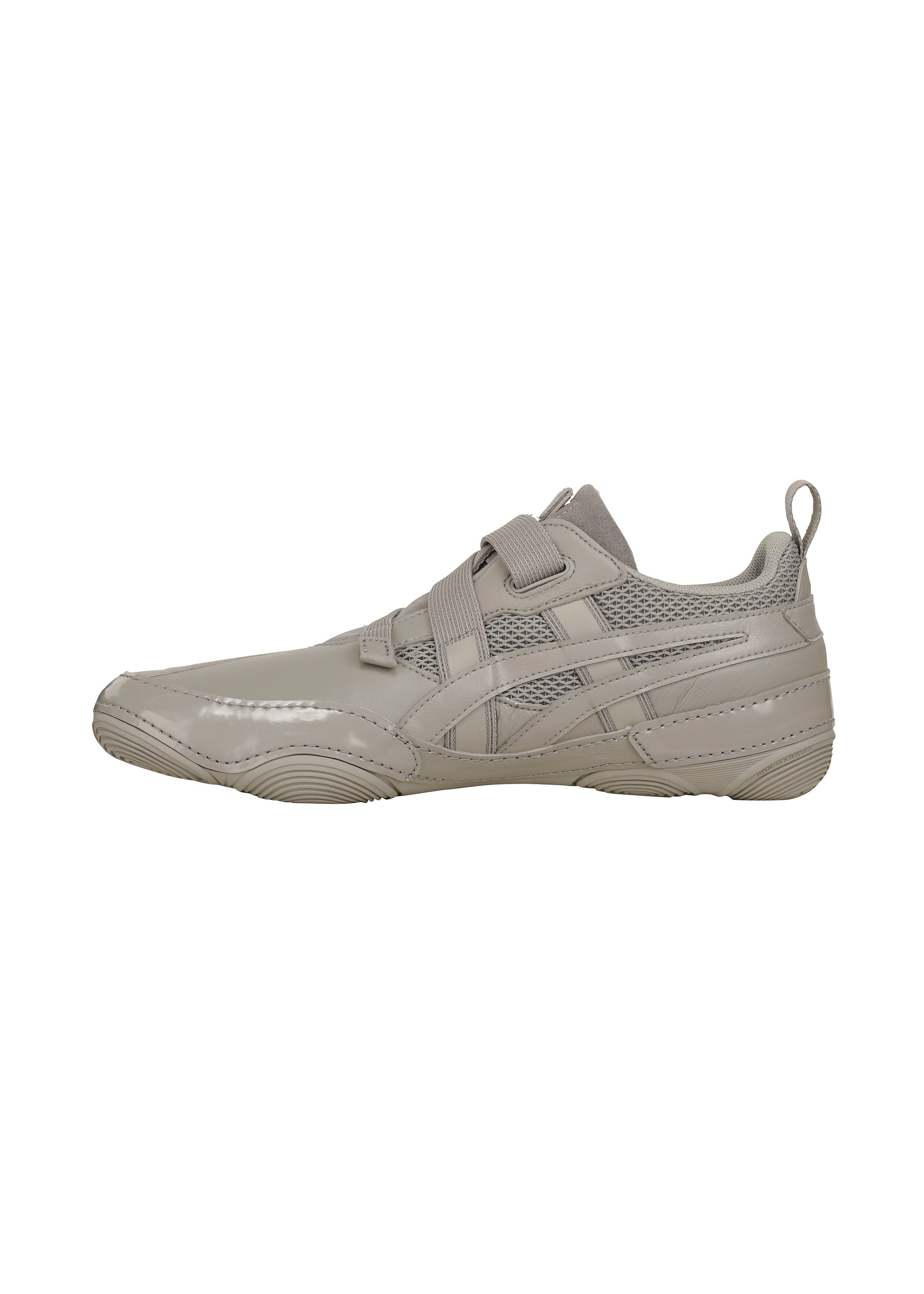 Zoomed view The ISSEY MIYAKE FOOT HYPER TAPING is a light gray sneaker with mesh and synthetic panels, hook-and-loop strap, heel pull tab, and textured rubber sole—shown in left side view on a white background.