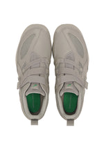 A pair of light gray ISSEY MIYAKE FOOT HYPER TAPING sneakers with mesh and leather details, green insoles and laces, viewed from above on a white background.