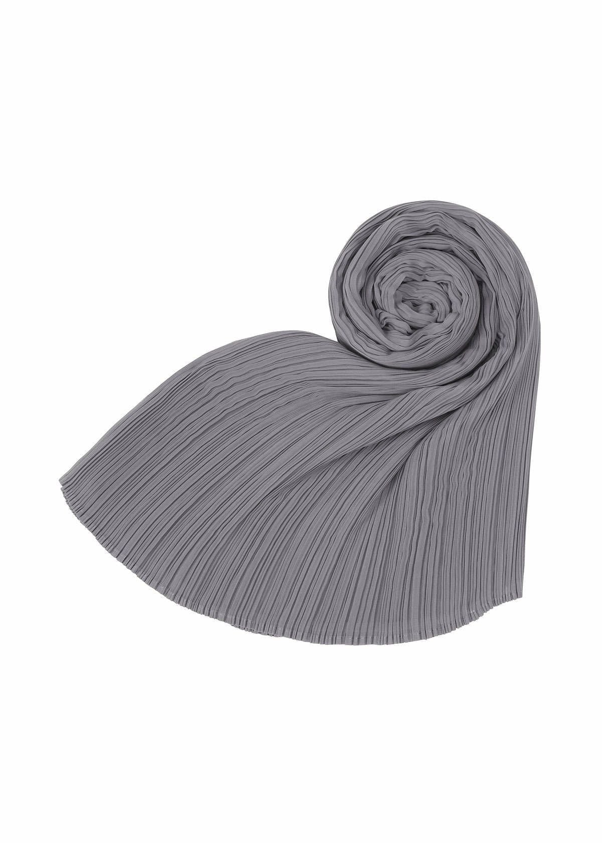 The BASIC MADAME-T SMALL by PLEATS PLEASE ISSEY MIYAKE is shown in gray, neatly rolled at one end with the rest of the stole fanned out against a white background. view 4 of 6