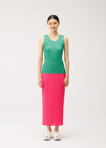 A model wearing a PLEATS PLEASE ISSEY MIYAKE NEW COLORFUL BASICS 5 green, round-neck sleeveless top and a long pink pleated skirt with white sneakers.