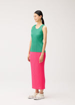 A woman wearing a NEW COLORFUL BASICS 5 round-neck sleeveless top and a long pink pleated skirt with light-colored sneakers.