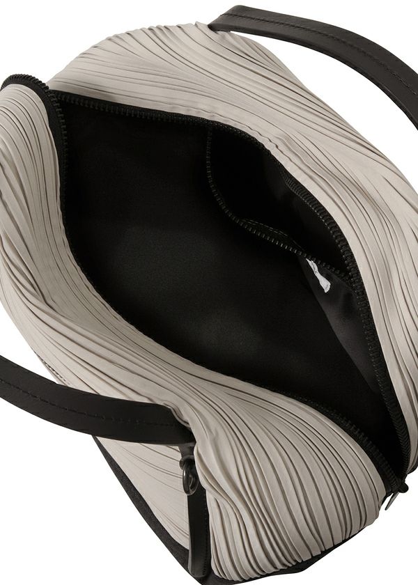 A top view of the BIAS PLEATS BAG by PLEATS PLEASE ISSEY MIYAKE shows its open beige pleated, textured exterior, black lining, visible zipper, black handles, and an attached strap for versatile shoulder bag styling. view 8 of 8