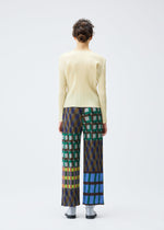 A person faces away, wearing the HARMONY long-sleeve ribbed top and wide-leg geometric print pants by PLEATS PLEASE ISSEY MIYAKE, against a plain white background.