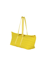 The PLEATS PLEASE ISSEY MIYAKE PP59-AG632 is a yellow oblong tote bag with ribbed fabric, horizontal pleats, long handles, and a zipper closure, shown on a white background.