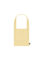 The CREPE KNIT BAG by PLEATS PLEASE ISSEY MIYAKE is a light yellow, rectangular pleated tote with a single handle, front pocket, and small black logo tag in the bottom right corner, shown against a white background. - CREAM YELLOW （no.30）