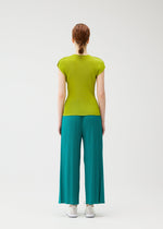 A person with red hair in a braid, seen from behind, wears the MIST JUNE set by PLEATS PLEASE ISSEY MIYAKE—featuring a fitted lime green round-neck top and teal finely pleated wide-leg pants—against a plain white background.