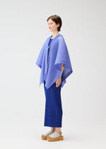 A person stands in profile against a white background, wearing the LUCID PLEATS set—light blue, three-dimensional cape-style top and pleated pants—from PLEATS PLEASE ISSEY MIYAKE, paired with beige platform sandals.