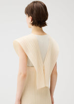 A person with short brown hair faces away, wearing the LUCID PLEATS sleeveless cream top by PLEATS PLEASE ISSEY MIYAKE, featuring wide pleated shoulders and a versatile design. The background is plain white.