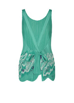 The I SPY! sleeveless pleated green top by PLEATS PLEASE ISSEY MIYAKE features a scoop neckline, scalloped hem, two front waist ties, and beach treasure-inspired white-and-blue embroidered wavy patterns on the lower front.