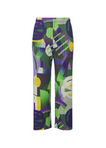 The PLAYGROUND pants by PLEATS PLEASE ISSEY MIYAKE feature a bold, colorful abstract geometric pattern in green, purple, yellow, and white with playful brushstroke-inspired shapes. - PURPLE （no.81）