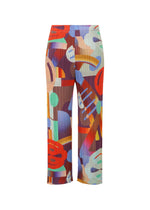PLAYGROUND by PLEATS PLEASE ISSEY MIYAKE: High-waisted straight-leg pants with a colorful abstract geometric pattern in red, blue, orange, green, and lavender on brown. Playful and stylish design.