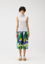 A person with short curly hair wears the PLAYGROUND sleeveless high-neck white pleated top and geometric culotte shorts by PLEATS PLEASE ISSEY MIYAKE, standing against a plain white background.