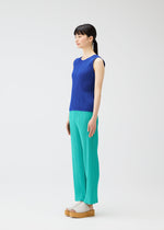 A woman with long dark hair in a ponytail models MONTHLY COLORS : MAY by PLEATS PLEASE ISSEY MIYAKE—a chic blue sleeveless tank top and light teal pants—effortlessly styled with beige platform sandals against a plain white background.