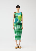 A woman with straight dark hair wears the calf-length, sleeveless MARKET dress by PLEATS PLEASE ISSEY MIYAKE, featuring a green and white checkered pattern with colorful abstract shapes, against a plain white background. She pairs it with platform sandals.