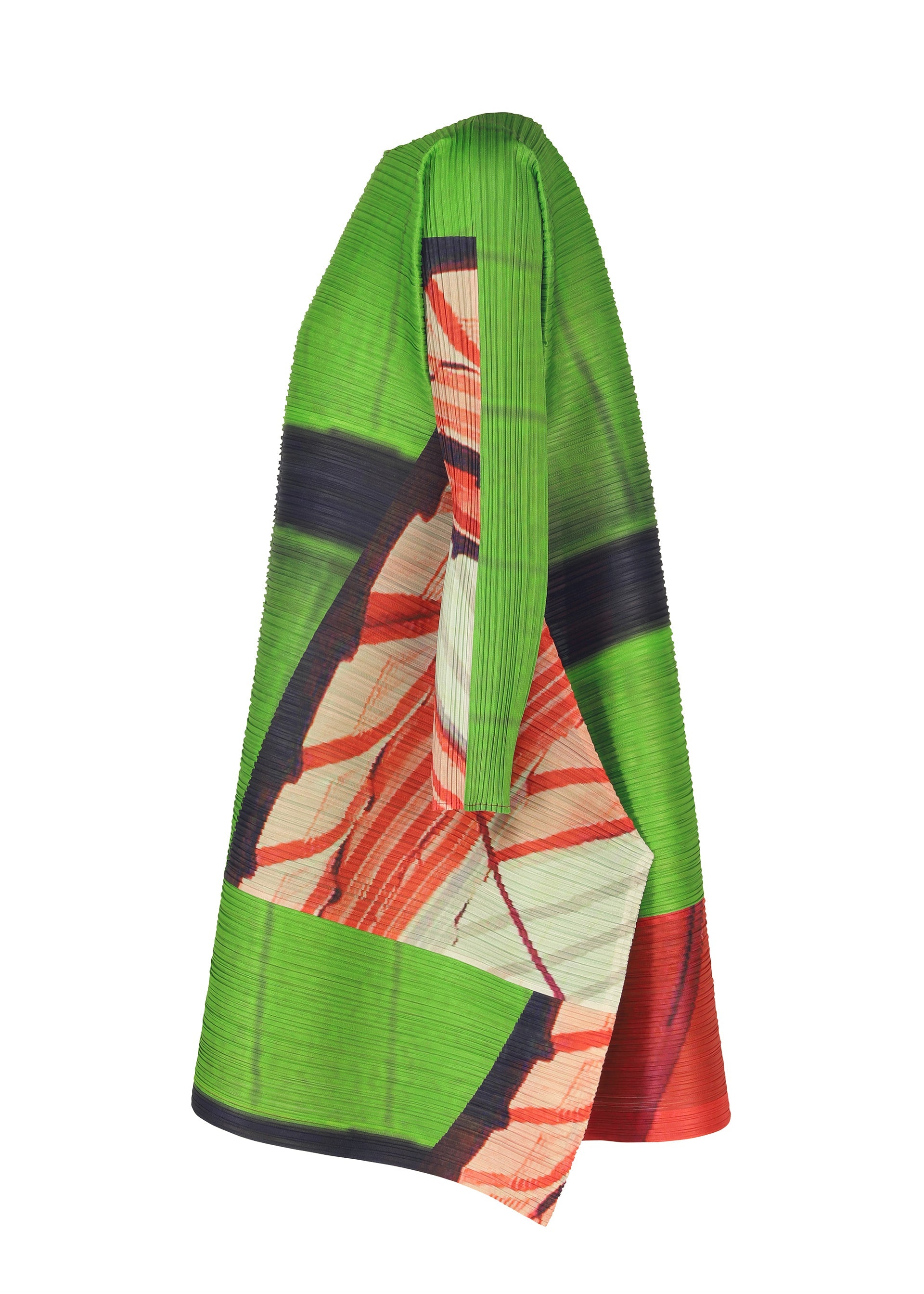 Zoomed view The CITY COLLAGE tunic by PLEATS PLEASE ISSEY MIYAKE, featuring sculptural pleats and vibrant green, red, black, and cream abstract patterns, is shown in side profile on a mannequin against a white background.