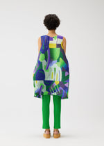 A person with short curly hair, seen from behind, wears the PLAYGROUND sleeveless tunic and green ribbed pants by PLEATS PLEASE ISSEY MIYAKE, with tan platform sandals, standing against a white background.