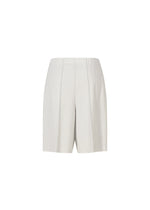 The A-POC BOTTOMS by PLEATS PLEASE ISSEY MIYAKE are white high-waisted pleated shorts with subtle pinstripes, a relaxed fit, elastic waistband, and defined pleat lines, shown against a plain white background.