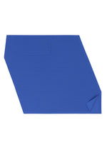 A-POC SEA GLASS by PLEATS PLEASE ISSEY MIYAKE is a blue placemat with sea glass-inspired irregular shapes, a small folded corner, and a rectangular stitched detail, shown on a white background.