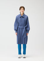 A person faces forward in a PLEATS PLEASE ISSEY MIYAKE SMOOTH COAT, a wind-resistant blue trench with Keshi pleats and matching belt, bright blue pleated pants, and white shoes, against a plain white background.