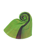 The CITY COLLAGE MADAME-T by PLEATS PLEASE ISSEY MIYAKE features pleated, translucent green fabric with black and brown stripes, artfully rolled into a spiral shape on a white background.