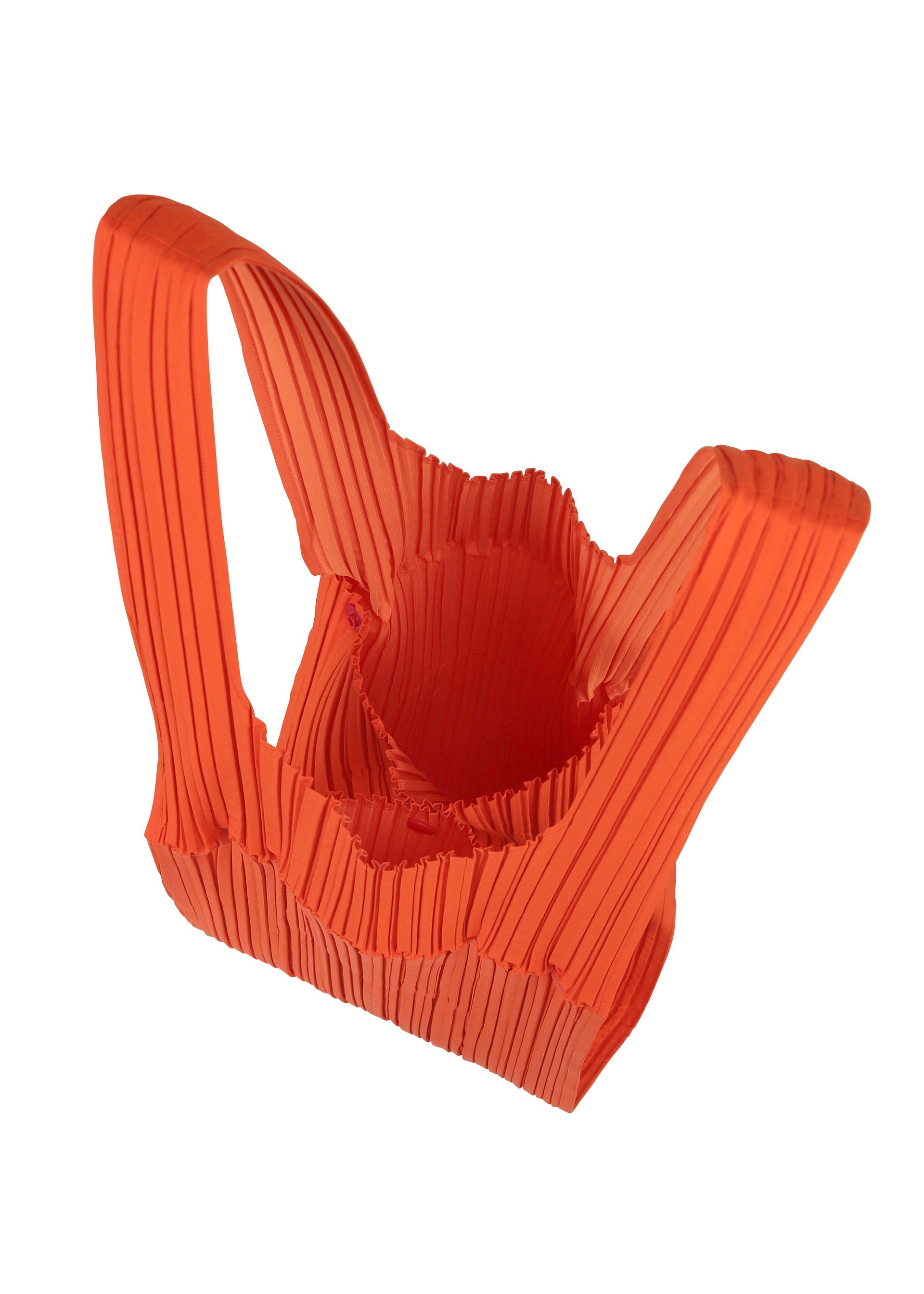 Zoomed view The PLEATS PLEASE ISSEY MIYAKE PLEATS BRIDGE BAG is a bright orange, abstract tote with two handles and a ribbed, textured surface. Distinctively designed, it's shown from above against a white background.