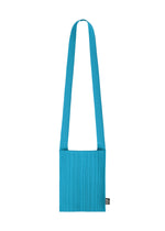 The CREPE KNIT BAG by PLEATS PLEASE ISSEY MIYAKE is a bright blue, rectangular pleated bag with a wide matching strap and a black label, shown on a white background. Washable and practical, it’s both stylish and functional. - DEEP BLUE （no.76）