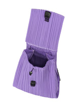 The PLEATS KNAPSACK by PLEATS PLEASE ISSEY MIYAKE in lavender features pleats, a flap with buckle closure, an expandable design, spacious lined interior, and a secure drawstring top for functional style.