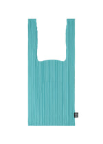 The PLEATS SHOPPING TOTE by PLEATS PLEASE ISSEY MIYAKE is a turquoise, rectangular pleated bag with two handles and a small black tag on the bottom right, shown against a plain white background. - TURQUOISE GREEN （no.66）