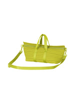 The PLEATS BOSTON BAG by PLEATS PLEASE ISSEY MIYAKE is a lime green, oblong bag with textured horizontal pleats, matching handles, and a detachable shoulder strap, shown on a white background.