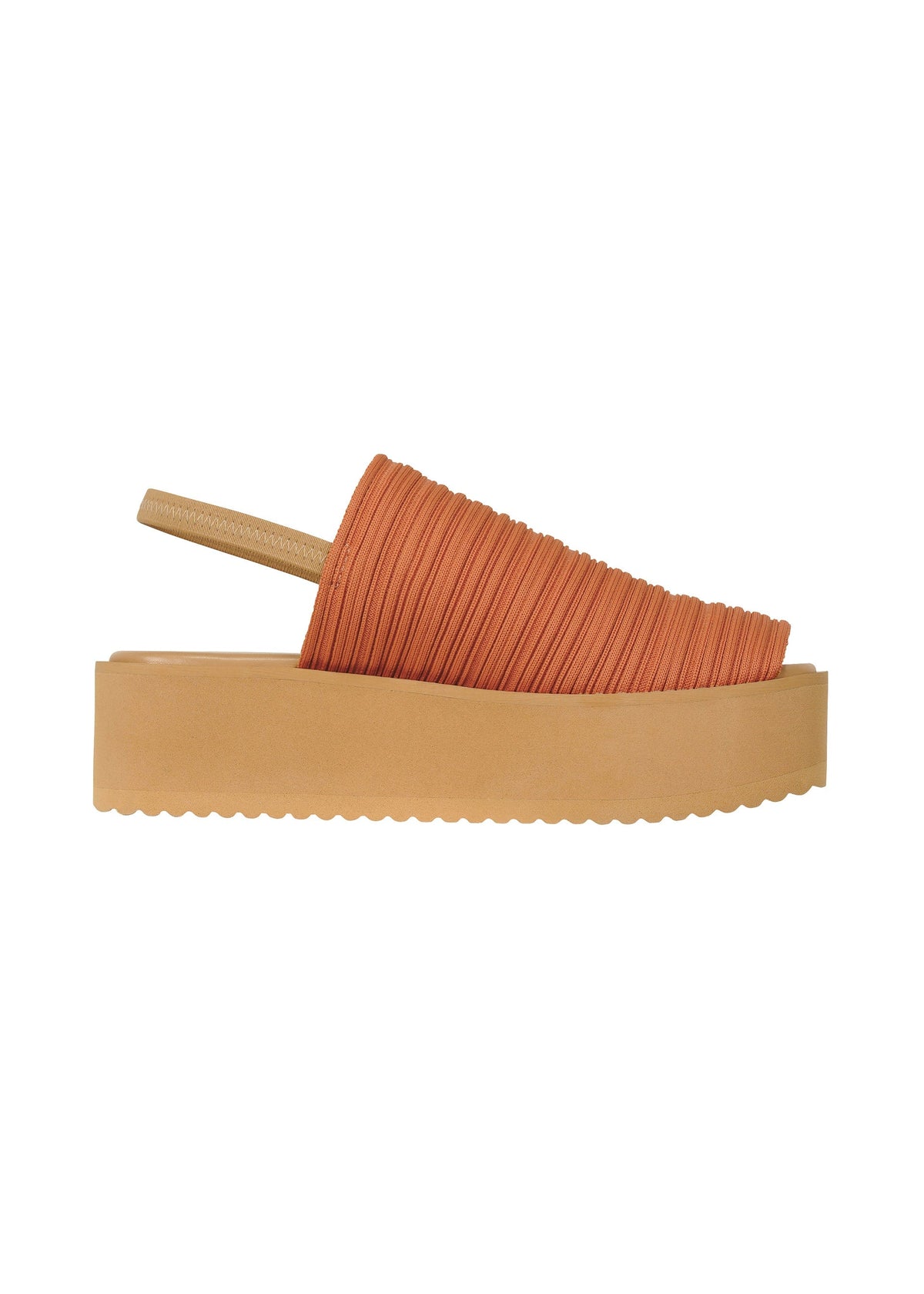 A side view of the PLEATS PLEASE ISSEY MIYAKE PLEATS KNIT SANDALS shows a tan platform, thick sole, orange textured pleated upper, and a slim beige back strap. view 4 of 10