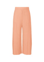 The MONTHLY COLORS : JULY pants by PLEATS PLEASE ISSEY MIYAKE feature a peach hue, wide-leg pleated design, elastic waistband, and handy pockets, shown against a white background. - PALE ORANGE （no.30）