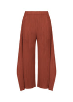 The MONTHLY COLORS : SEPTEMBER pants by PLEATS PLEASE ISSEY MIYAKE feature a rust hue with a pleated texture, designed in a wide-leg, high-waisted flare silhouette. With an elastic waistband and flowy, loose-fitting legs, these pants offer a gentle tone that highlights their sophisticated color composition. Shown against a plain white background. - RED BROWN （no.49）