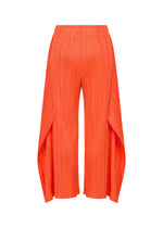 The MONTHLY COLORS : SEPTEMBER pants by PLEATS PLEASE ISSEY MIYAKE feature a vivid orange hue, pleated flare silhouette, wide draped side panels, and cropped hems for a bold and striking look, shown against a white background.
