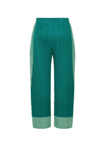 TWIRL pants by PLEATS PLEASE ISSEY MIYAKE in green, featuring pleats and an elastic waistband. The wide, cropped legs are accented with lighter green panels at the sides and hem, subtly inspired by norimaki sushi. No visible side pockets or fastenings. Displayed against a white background.