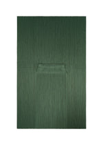 FLUTTER by PLEATS PLEASE ISSEY MIYAKE features a unique quadrilateral skirt in textured dark green, designed with vertical pleats and a central horizontal fold that create a subtle geometric pattern reminiscent of minimalist artwork on a white backdrop.