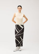A person stands smiling with hands behind their back, wearing a sleeveless cream top and the FOLD LINE black and white geometric patterned straight skirt by PLEATS PLEASE ISSEY MIYAKE—featuring minimalist design details—paired with white shoes against a plain light background.