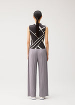 A person stands with their back to the camera, wearing the FOLD LINE high-neck sleeveless black top featuring a white diagonal wrapping pattern and wide-legged, light gray pleated pants from PLEATS PLEASE ISSEY MIYAKE. Their hair is straight and tied back in a low ponytail. The plain white background further highlights the minimalist design.