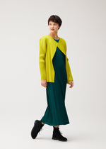 Wearing MONTHLY COLORS : OCTOBER from PLEATS PLEASE ISSEY MIYAKE, a person layers a bright yellow cardigan over a green pleated dress and black shoes against a plain white background.