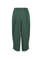 The A-POC BOTTOMS by PLEATS PLEASE ISSEY MIYAKE are dark green, loose-fitting cropped pleated pants featuring an elastic waistband, a subtle vertical texture inspired by A-POC structures, and small side slits at the hem, shown against a white background.