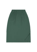 The A-POC BOTTOMS by PLEATS PLEASE ISSEY MIYAKE is a green, knee-length pleated skirt featuring an elastic waistband and a small side slit near the bottom hem, shown laid flat on a white background.