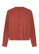 The SMOOTH COAT by PLEATS PLEASE ISSEY MIYAKE features a rust hue, long sleeves, pleated texture, and a round neckline with a button-down front. Its elasticated waist and cuffs, along with the thick fabric construction, make this coat an ideal layering piece for cooler seasons.