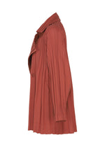 Side view of the SMOOTH COAT by PLEATS PLEASE ISSEY MIYAKE—a long-sleeved, rust-colored coat featuring pleats, a wide collar, a single visible button, and crafted from thick fabric—shown on a white background, perfect for chilly weather.