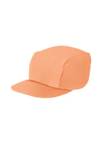 The PLEATS CAP by PLEATS PLEASE ISSEY MIYAKE is a peach-colored cap crafted from ribbed, textured fabric, featuring a flat bill and a structured crown for comfortable wear. - PALE ORANGE （no.30）