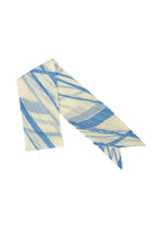 The FOLD LINE SCARF by PLEATS PLEASE ISSEY MIYAKE is a pleated, narrow accessory featuring pointed ends and striking diagonal blue and cream stripes, evoking the elegance of gift wrapping, shown on a white background. - OFF WHITE （no.02）