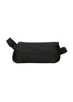 The BIAS PLEATS WAIST BAG by PLEATS PLEASE ISSEY MIYAKE features black diagonal pleats and an adjustable strap, creating a sleek, rectangular silhouette and adding a stylish accent against a plain white background. - BLACK （no.15）