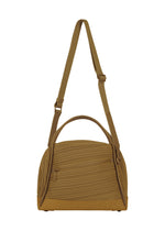 The BIAS PLEATS BAG by PLEATS PLEASE ISSEY MIYAKE features a mustard yellow hue, a distinctive diagonal pleating texture, a front zip pocket, top handle, and an adjustable shoulder strap, shown against a plain white background. - KHAKI （no.65）