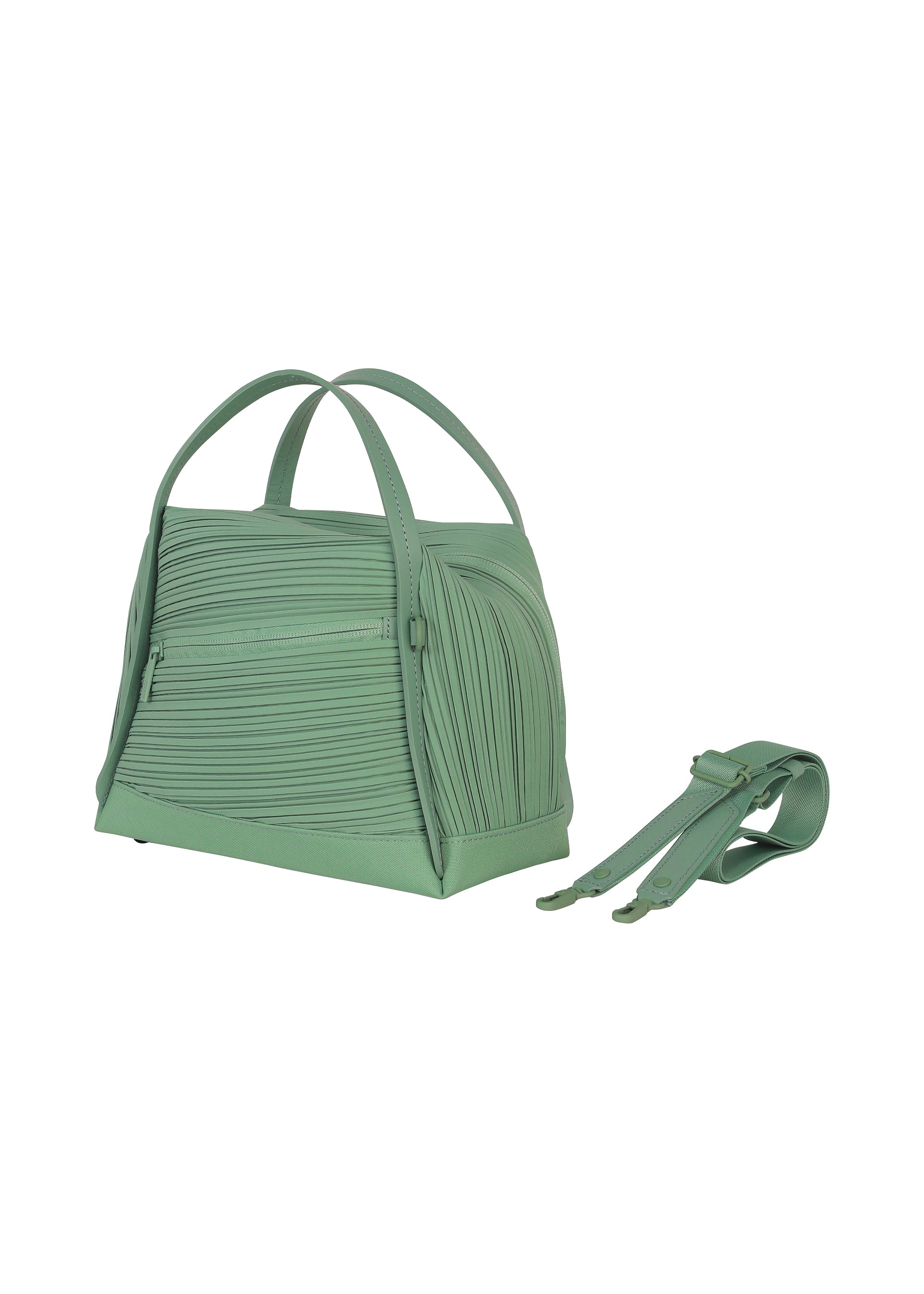 Zoomed view The BIAS PLEATS BAG by PLEATS PLEASE ISSEY MIYAKE is shown in light green with textured, diagonal pleating, two handles, and a detachable matching strap placed beside it on a white background.