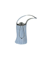 The PLEATS SWAN BAG by PLEATS PLEASE ISSEY MIYAKE is an elegant light blue handbag with subtle pleating, a curved handle, and a drawstring closure, showcasing a refined silhouette against a white background. - LIGHT BLUE （no.70）