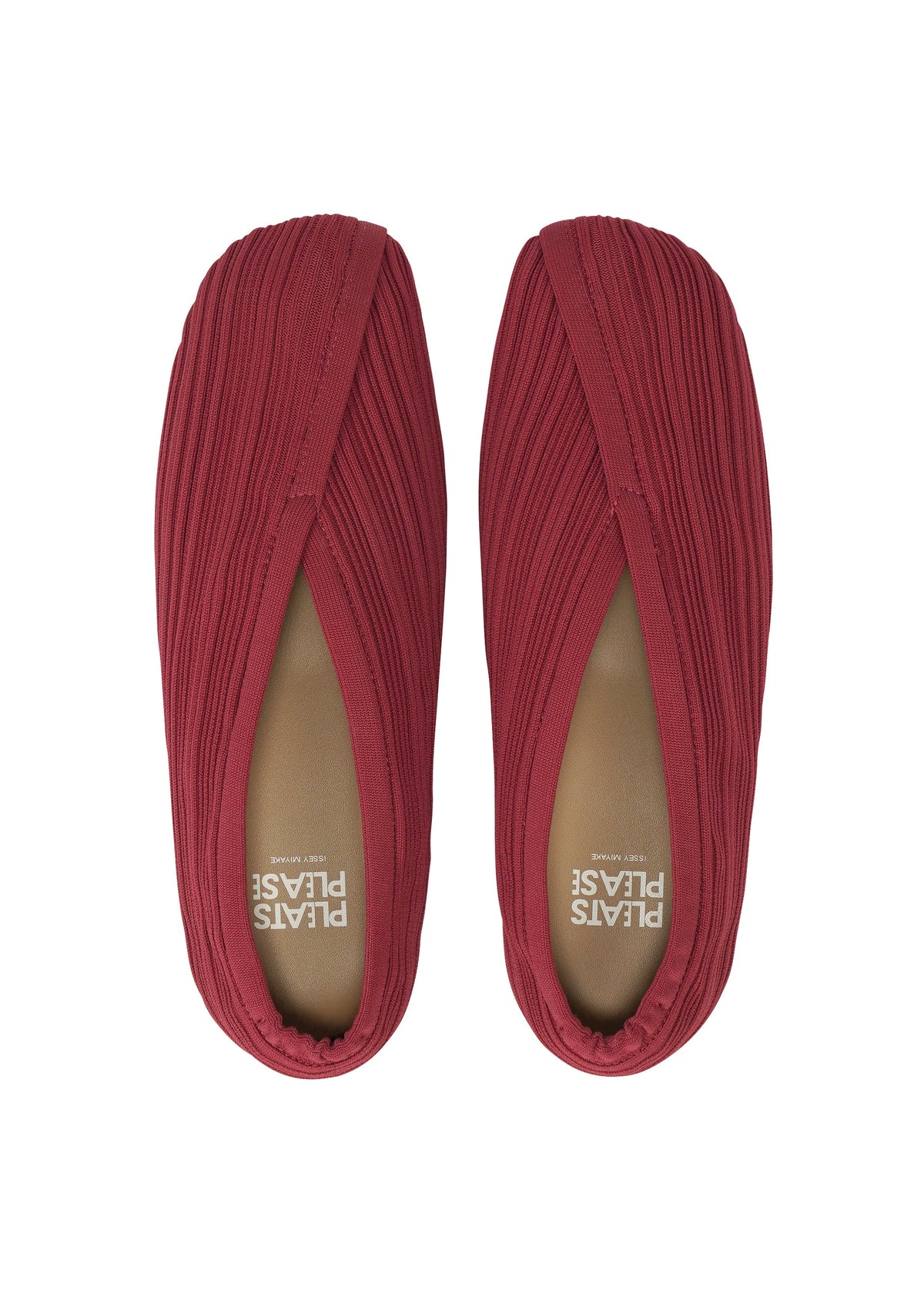 A pair of red KNIT BALLET SHOES by PLEATS PLEASE ISSEY MIYAKE, seen from above, showcase a pleated, knitted fabric texture and a subtly pointed toe. The insoles are marked with “PLATS PLEASE” in white lettering. view 3 of 4